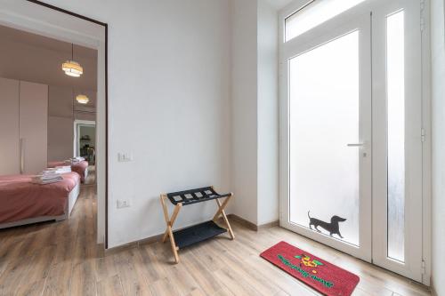 a bedroom with a mirror and a dog sticker on the wall at Appartamento indipendente Clarò Guesthouse in Quartucciu