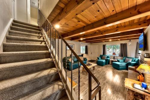 a staircase in a living room with blue chairs and a couch at 2782B Tahoe River Chalet in South Lake Tahoe
