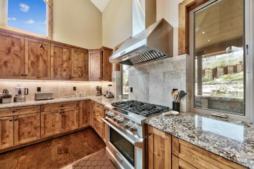 a kitchen with wooden cabinets and a stove top oven at 1008C Mountain View Retreat in South Lake Tahoe
