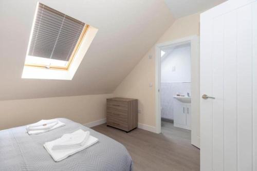a bedroom with a bed and a sink and a window at SAV Stays Apartments Clarence Street-Loughborough in Loughborough