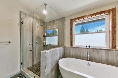 a bathroom with a tub and a glass shower at 1008C Mountain View Retreat in South Lake Tahoe