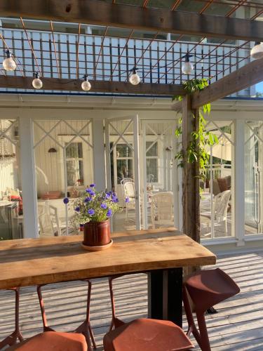 a wooden table and chairs on a patio with a table at Fräknero in Ljungskile