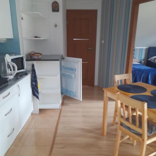 a kitchen and dining room with a table at Willa Gracja in Wisła