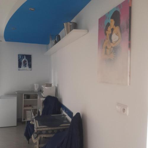 a living room with a painting on the wall at Willa Gracja in Wisła