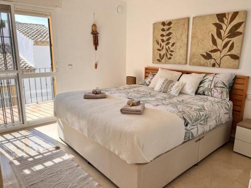 a bedroom with a bed with two towels on it at Casa Carmen in Marbella