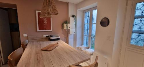 a dining room with a wooden table and chairs at Terracotta - Séjour à Auxerre in Auxerre