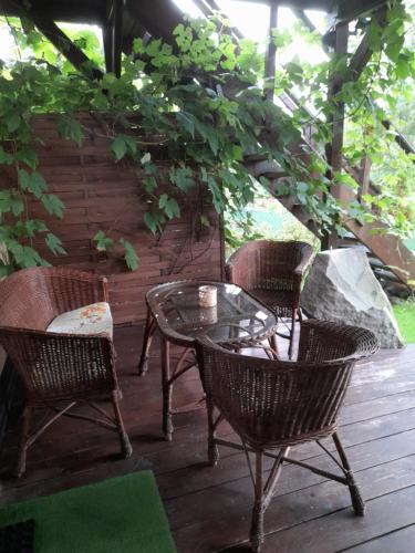 a patio with a table and chairs on a deck at Willa Gracja in Wisła