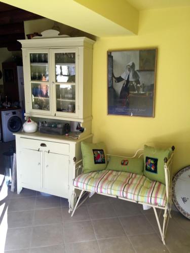 a living room with a couch and a cabinet at Maison Kyriakou in Stavrinídes