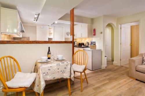 a kitchen and dining room with a table and chairs at Thomas Fold Flat in Ambleside