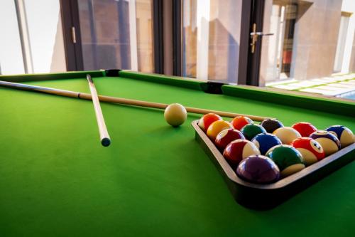 a pool table with a cue and balls on it at The Villa Haramous in Djibouti