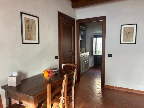 a dining room table with a bowl of fruit on it at Palazzo Contelori in Terni