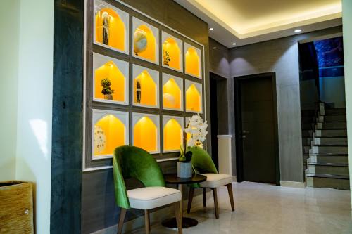 a dining room with a table and green chairs at The Villa Haramous in Djibouti