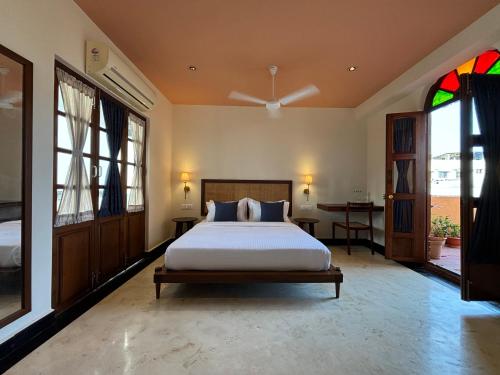 a bedroom with a bed and a stained glass window at Charme de Pondicherry by stayxp in Puducherry