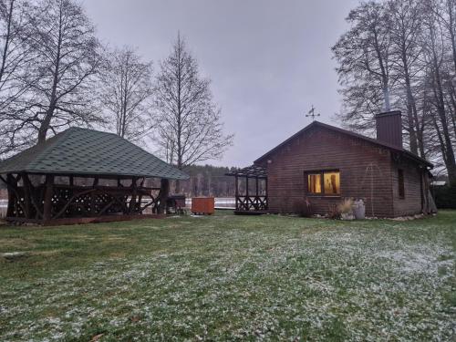 a log cabin with a window and a gazebo at Glamping Druskininkai in Grūtas