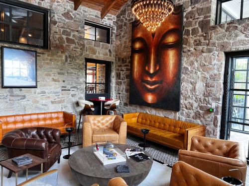 a living room with leather furniture and a large head on the wall at Logan Inn in New Hope
