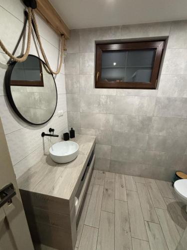 a bathroom with two sinks and a mirror at Skrzynia in Skrzynia