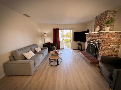 a living room with a couch and a fireplace at gateway to the ocean in Hawthorne
