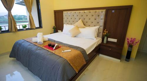 a bedroom with a large bed with a tray on it at Cascade Farmhouse in Kārli