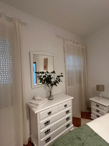a bedroom with a white dresser with a mirror at Casas PARAJE NATURAL in Zahara de la Sierra
