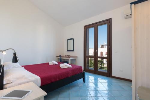 a hotel room with a bed and a balcony at Casa Vacanza Azzurra 4 in San Vito lo Capo
