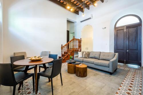 a living room with a table and a couch at Casa Las Ruinas by Stay with Bear in San Juan