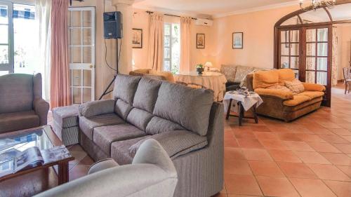 a living room with a couch and a table at Villa Delta by Casitas Select in Córdoba