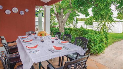a table with a white table cloth on a patio at Villa Delta by Casitas Select in Córdoba