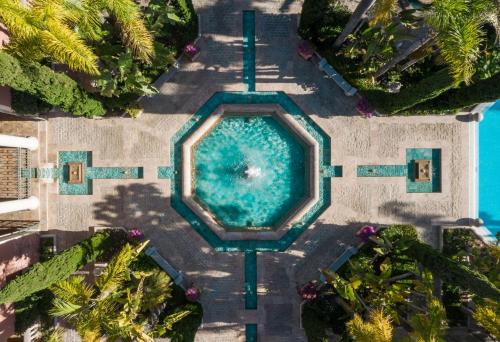 an overhead view of a swimming pool in a resort at Anantara Villa Padierna Palace Benahavís Marbella Resort - A Leading Hotel of the World in Estepona