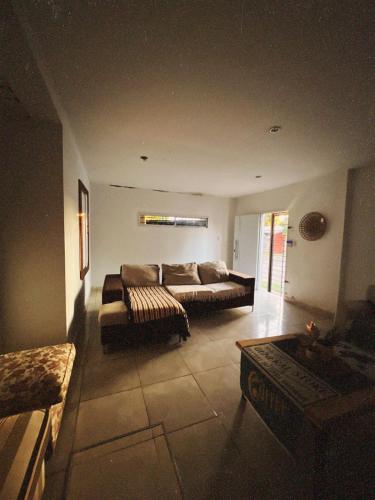 a living room with a couch and a table at Casa de luz in Posadas