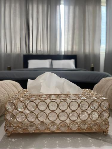 a silver box sitting on a table in a bedroom at Abu Dhabi Suave in Abu Dhabi