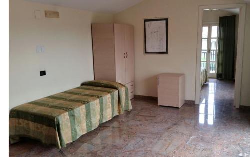 a bedroom with a bed and a cabinet in it at Hotel Borgo Verde in Catania