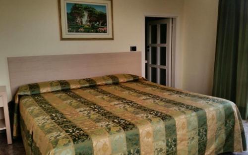 a bedroom with a bed with a blanket on it at Hotel Borgo Verde in Catania