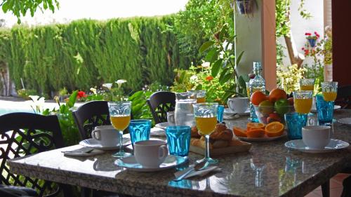 a table with food and glasses of orange juice at Villa Delta by Casitas Select in Córdoba