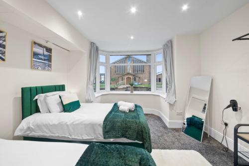 a bedroom with two beds and a window at Cooper House Stay - Large Stylish House in Oxford