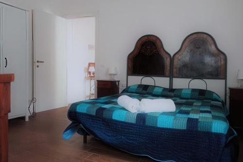 a bedroom with a bed with two towels on it at Inferno e Paradiso in Gradara
