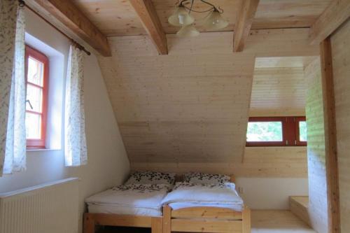 a small room with a bed in a cabin at Jezinka Dolní Morava in Dolní Morava