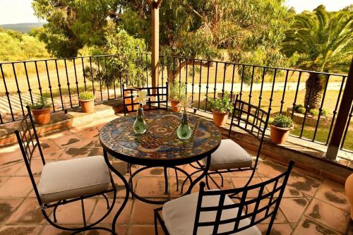 a table and chairs on a patio with a balcony at Mas Valoria in Peratallada