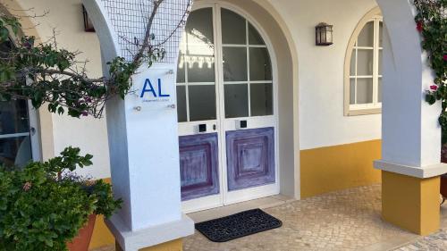 an entrance to a building with a purple door at O Pátio in Fernao Ferro