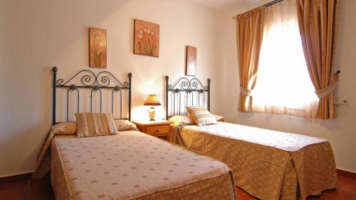 En eller flere senge i et værelse på Villa La Palma