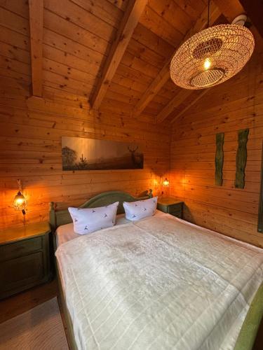 a bedroom with a bed in a wooden room at Blockhäuser Stamsried in Stamsried