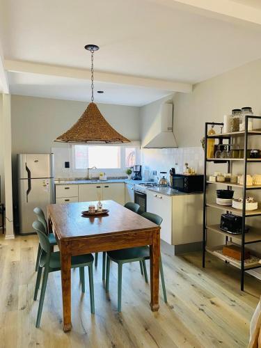 a kitchen with a wooden table and some chairs at Jalapeña in Comodoro Rivadavia