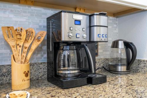 a coffee maker sitting on top of a counter at Themed Disney House 5 min to Disney Parks, Heated Pool, Jacuzzi, Gym and more in Orlando