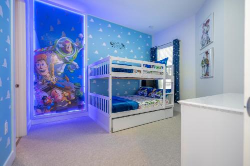 a bedroom with a bunk bed with a disney mural at Themed Disney House 5 min to Disney Parks, Heated Pool, Jacuzzi, Gym and more in Orlando
