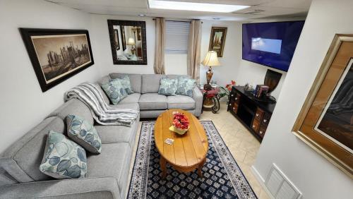 a living room with a couch and a table at The Cozy Nook Basement Apartment All To Yourself in Knoxville