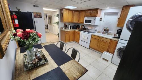 a kitchen with a table with a vase of flowers on it at The Cozy Nook Basement Apartment All To Yourself in Knoxville