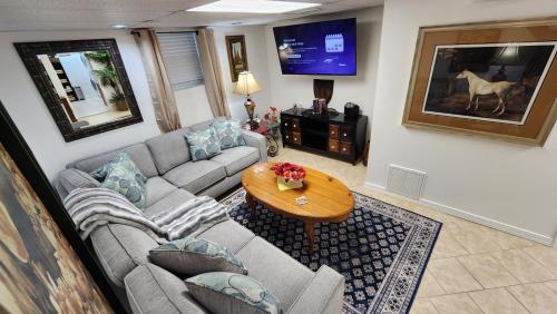a living room with a couch and a table at The Cozy Nook Basement Apartment All To Yourself in Knoxville
