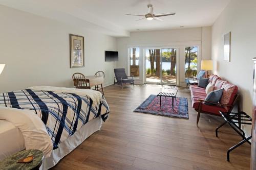 a bedroom with a bed and a living room at Long Lake Fox Den - Dog Friendly in Traverse City