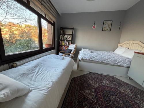 a bedroom with two beds and a window at Heavenly Peace Stunning View Terrace Jacuzzi in Istanbul