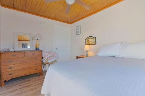 a bedroom with a white bed and a wooden ceiling at Renovated Camp Ellis Retreat - 2nd Floor in Saco