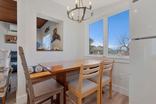 a dining room with a wooden table and chairs at Renovated Camp Ellis Retreat - 2nd Floor in Saco
